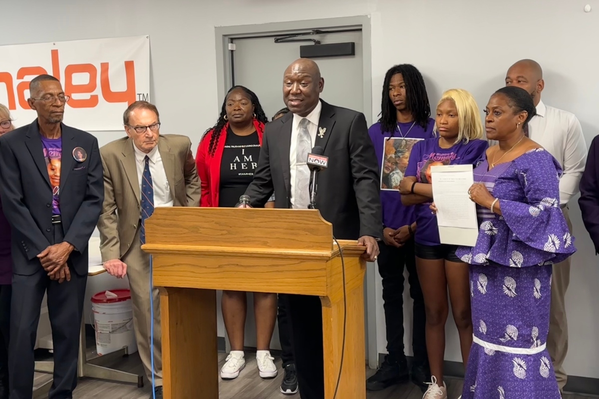 Attorney Benjamin Crump, at podium, speaks on Governer Pritzker signing "Sonya's Bill" into law. The law was named after a woman who was killed by a Sangamon County Sheriffs Deputy.