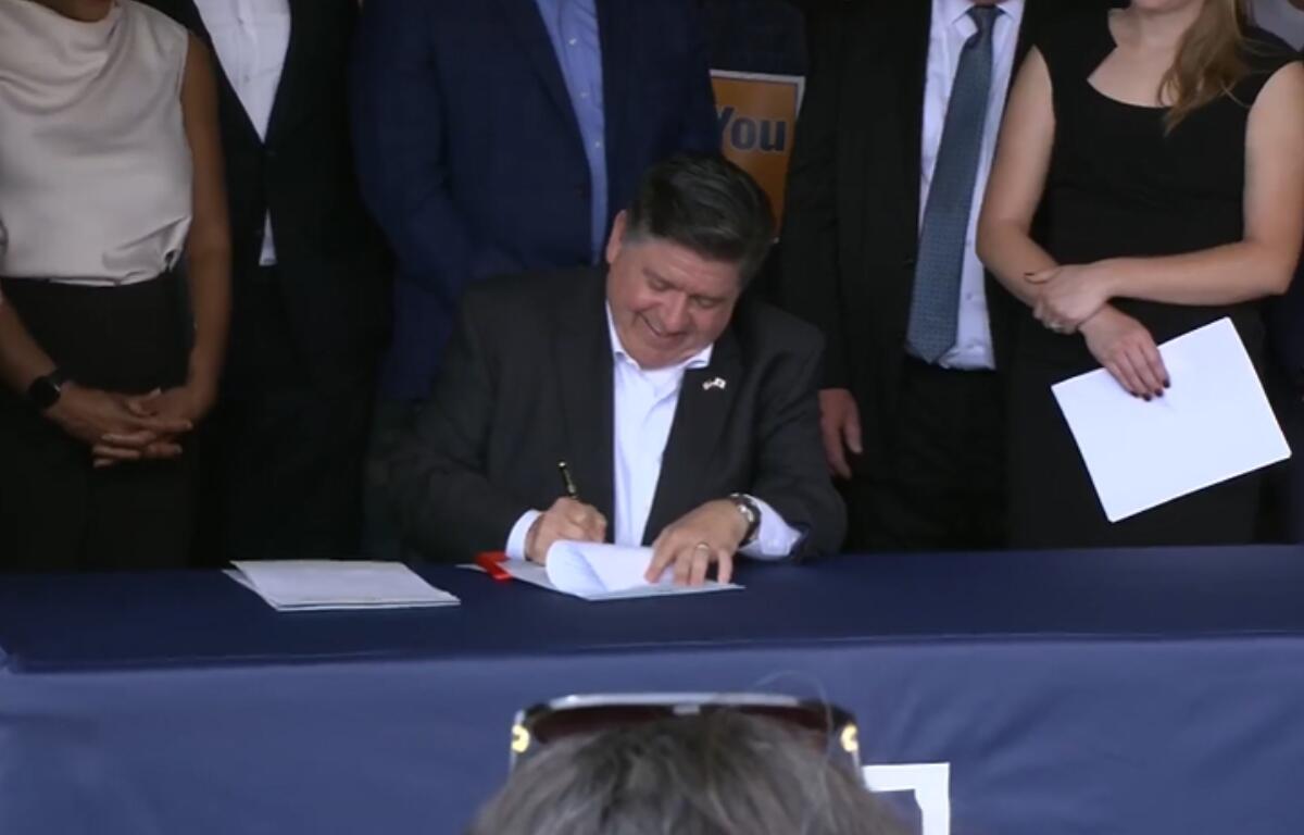 Governor JB Pritzker signs several union-backed bills at the Springfield AFL-CIO headquarters.