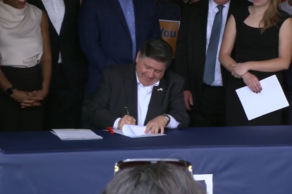 Governor JB Pritzker signs several union-backed bills at the Springfield AFL-CIO headquarters.