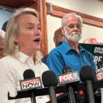 Springfield resident Bob Croteau, in blue, stands near Rep. Nikki Budzinski (D-Springfield) at a news conference at the AFL-CIO headquarters in downtown Springfield Aug. 21, 2025. Crouteau was one of a number of AFSCME union members who surrounded the Congresswoman.