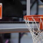 FILE - The WNBA logo is seen near a hoop before an WNBA basketball game at Mohegan Sun Arena, Tuesday, May 14, 2019, in Uncasville, Conn. (AP Photo/Jessica Hill, File)