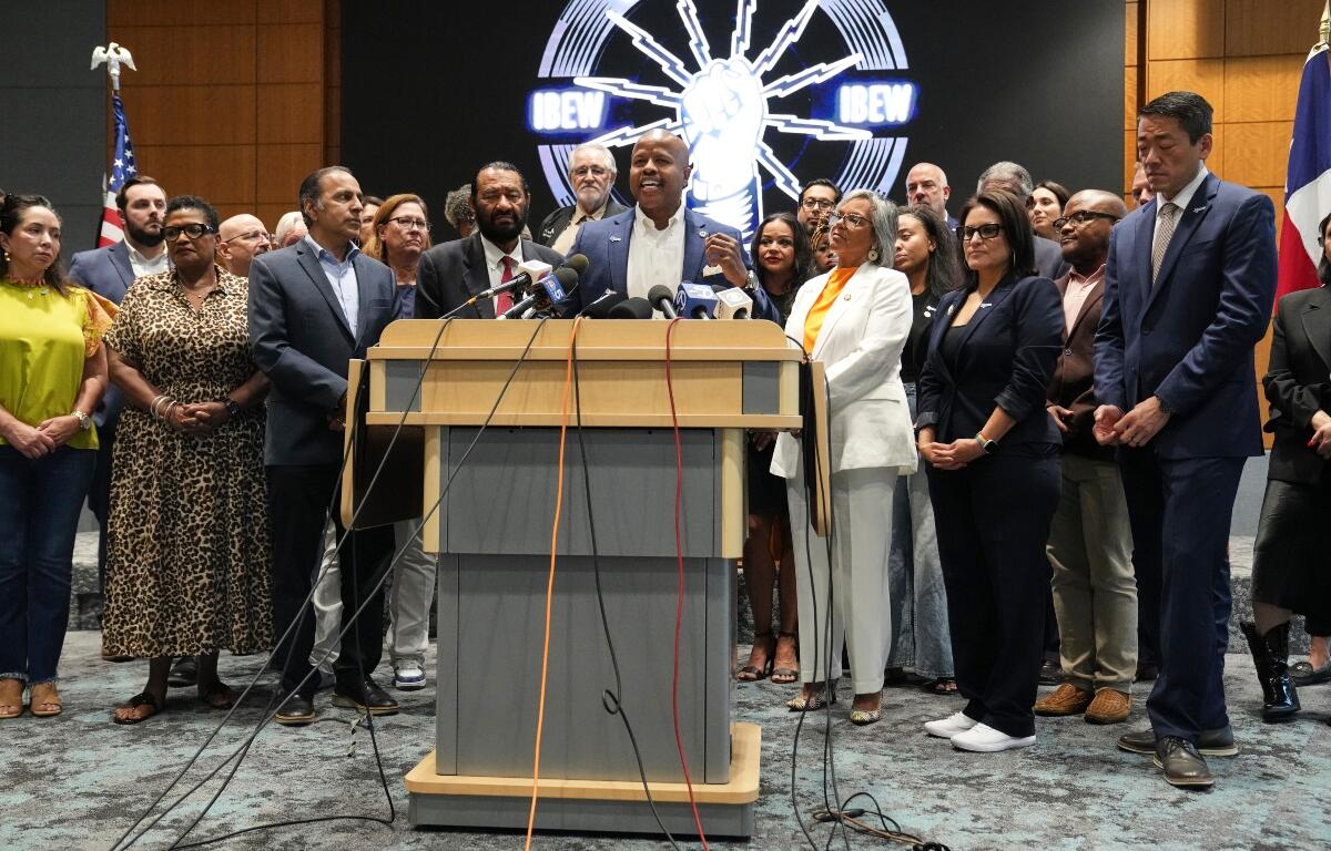 Democratic Texas Rep. Ron Reynolds, center, surrounded by other Texas House Democrats and Democratic members of Congress, speaks during a press conference at the Democratic Party in Warrenville, Ill., Monday, Aug. 4, 2025. (AP Photo/Nam Y. Huh)