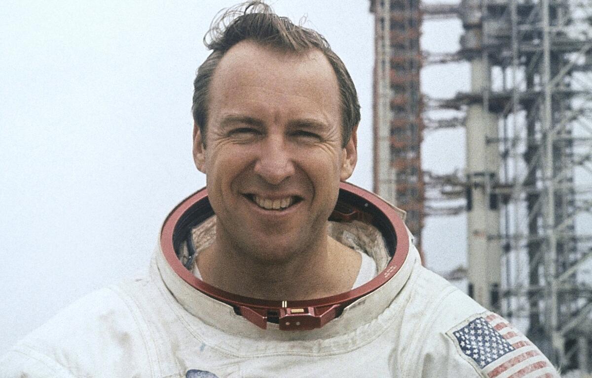 FILE - In this photo provided by NASA, astronaut James Lovell, Apollo 13 commander poses for a portrait in his space suit, Feb. 16, 1970. (AP Photo/NASA, File)