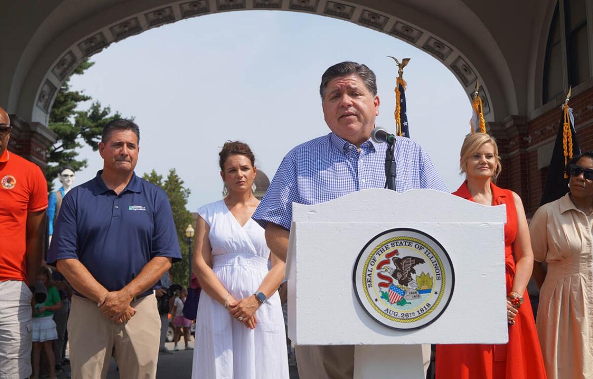 Gov. JB Pritzker speaks to reporters outside the Illinois State Fairgrounds after cutting a ribbon to officially open the fair on Thursday, Aug. 7, 2025. (Capitol News Illinois photo by Peter Hancock)