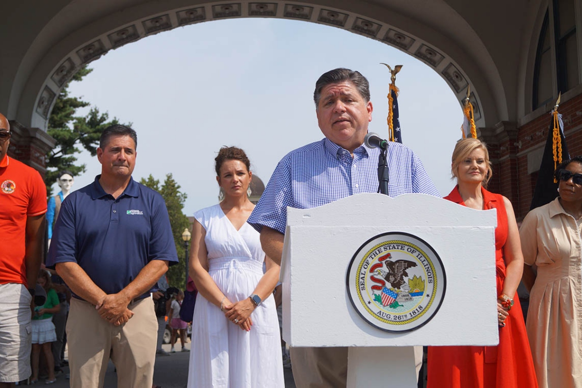 Gov. JB Pritzker speaks to reporters outside the Illinois State Fairgrounds after cutting a ribbon to officially open the fair on Thursday, Aug. 7, 2025. (Capitol News Illinois photo by Peter Hancock)