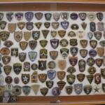 Law enforcement badges from sheriff and police departments across the state and the U.S. are displayed on a wall in the Pulaski County Courthouse. (Medill Illinois News Bureau photo by Maggie Dougherty)