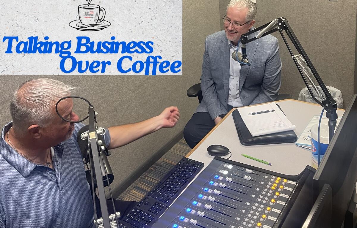 Chris Bullock, left, talks with Tim Whisler of The Whisler Agency.