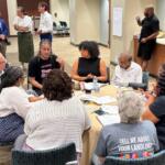 Members of the public and members of the Massey Commission discussed some of the commission's recommendations Monday night in small groups.