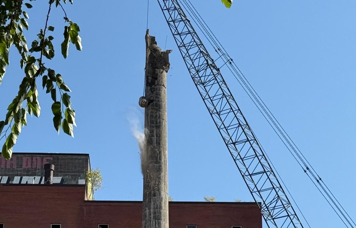 The wrecking ball continues demolition of a smokestack at the former Pillsbury Plant.
