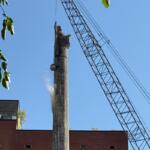 The wrecking ball continues demolition of a smokestack at the former Pillsbury Plant.