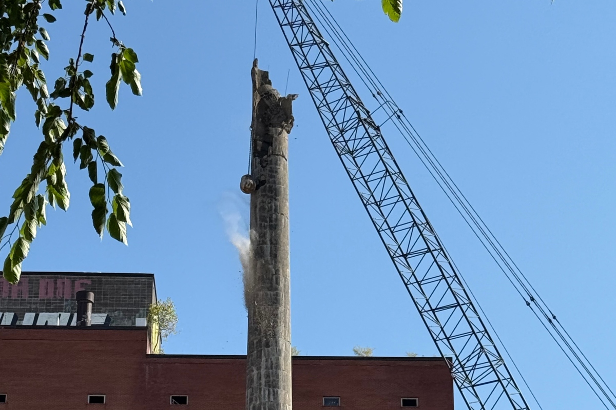 The wrecking ball continues demolition of a smokestack at the former Pillsbury Plant.