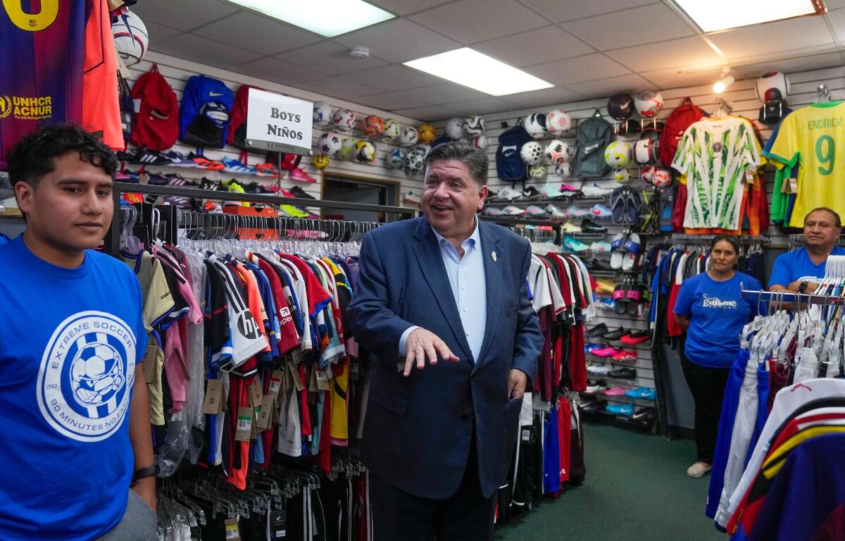 Illinois Gov. J.B. Pritzker visits with members of the family-owned soccer gear business Extreme Soccer, Thursday, Sept. 4, 2025, in Berwyn, Ill. (AP Photo/Erin Hooley)
