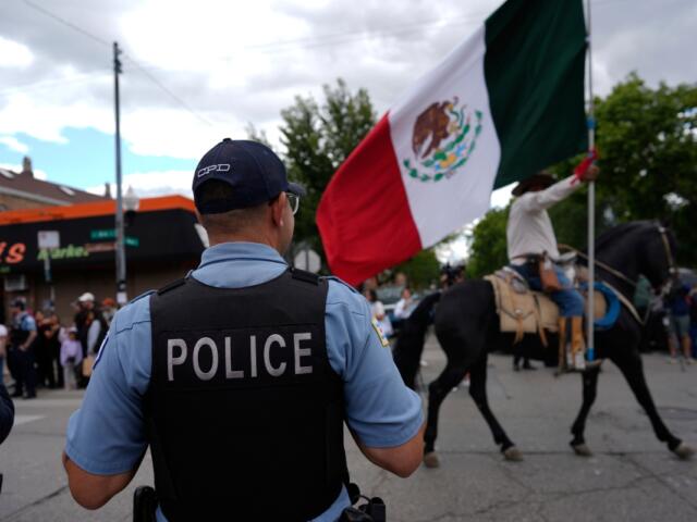 Police watch during the 2025 Pilsen Mexican Independence Day parade Saturday, Sept. 6, 2025, in Chicago. (AP Photo/Carolyn Kaster)