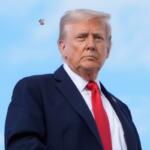A spotted lanternfly flies past President Donald Trump as he boards Air Force One, Thursday, Sept. 11, 2025, at Joint Base Andrews, Md., to travel to New York. (AP Photo/Alex Brandon)