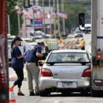 Investigators from the FBI survey the scene where an Immigration and Customs Enforcement officer shot and killed a suspect after the suspect drove his car at the arresting officers, Friday, Sept. 12, 2025, in Franklin Park, Ill. (AP Photo/Paul Beaty)
