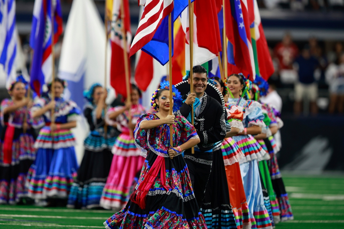 FILE - National flags from Latin American countries are displayed on the field during a celebration of Hispanic Heritage Month before an NFL football game between the Baltimore Ravens and Dallas Cowboys in Arlington, Texas, Sunday, Sept. 22, 2024. (AP Photo/Gareth Patterson, FILE)