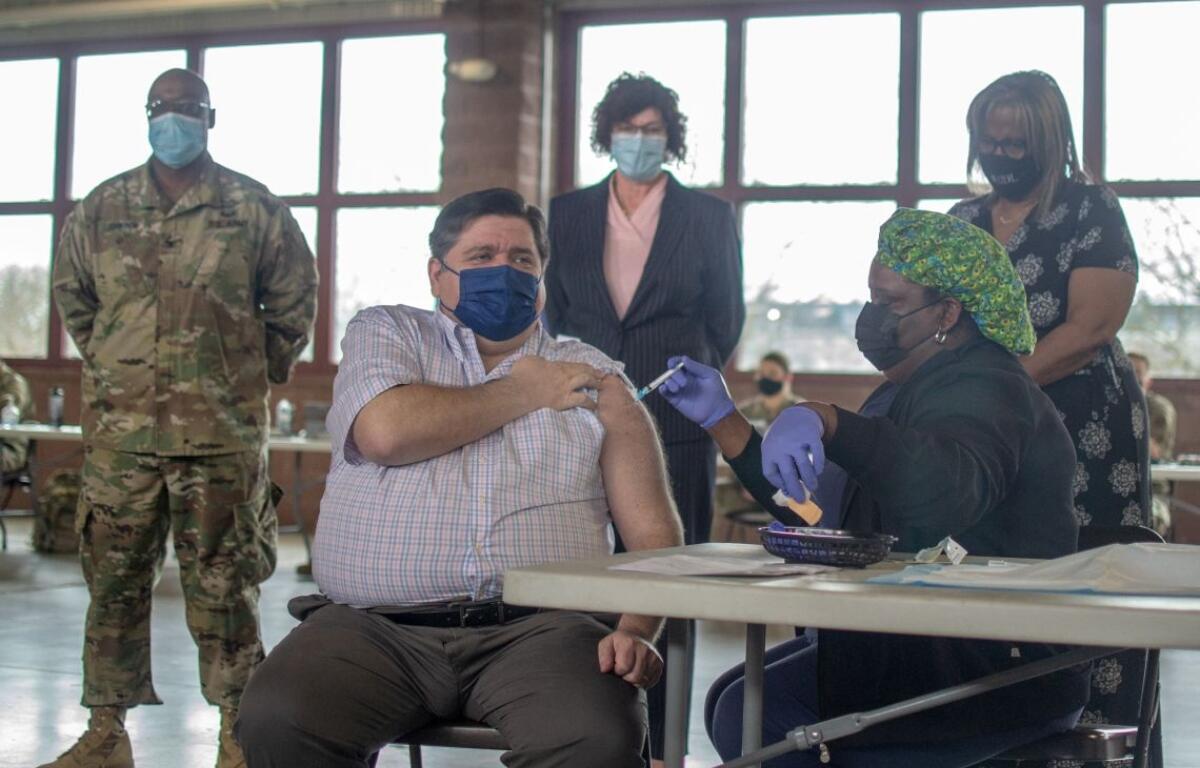 Gov. JB Pritzker receives his COVID-19 vaccine in 2022 at the Illinois State Fairgrounds. (Capitol News Illinois photo by Jerry Nowicki)