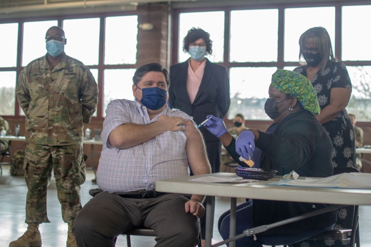 Gov. JB Pritzker receives his COVID-19 vaccine in 2022 at the Illinois State Fairgrounds. (Capitol News Illinois photo by Jerry Nowicki)