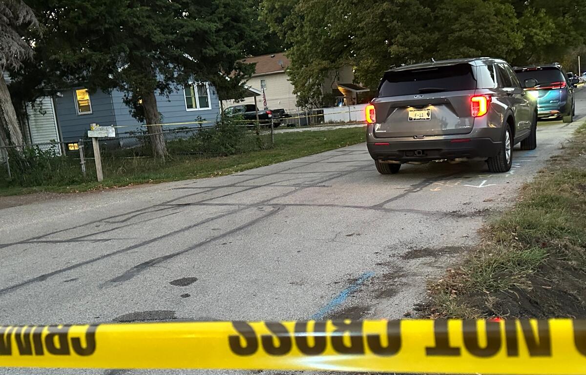 Three people were killed Thursday at the house, seen left, in the 3000 block of Hoover Ave.