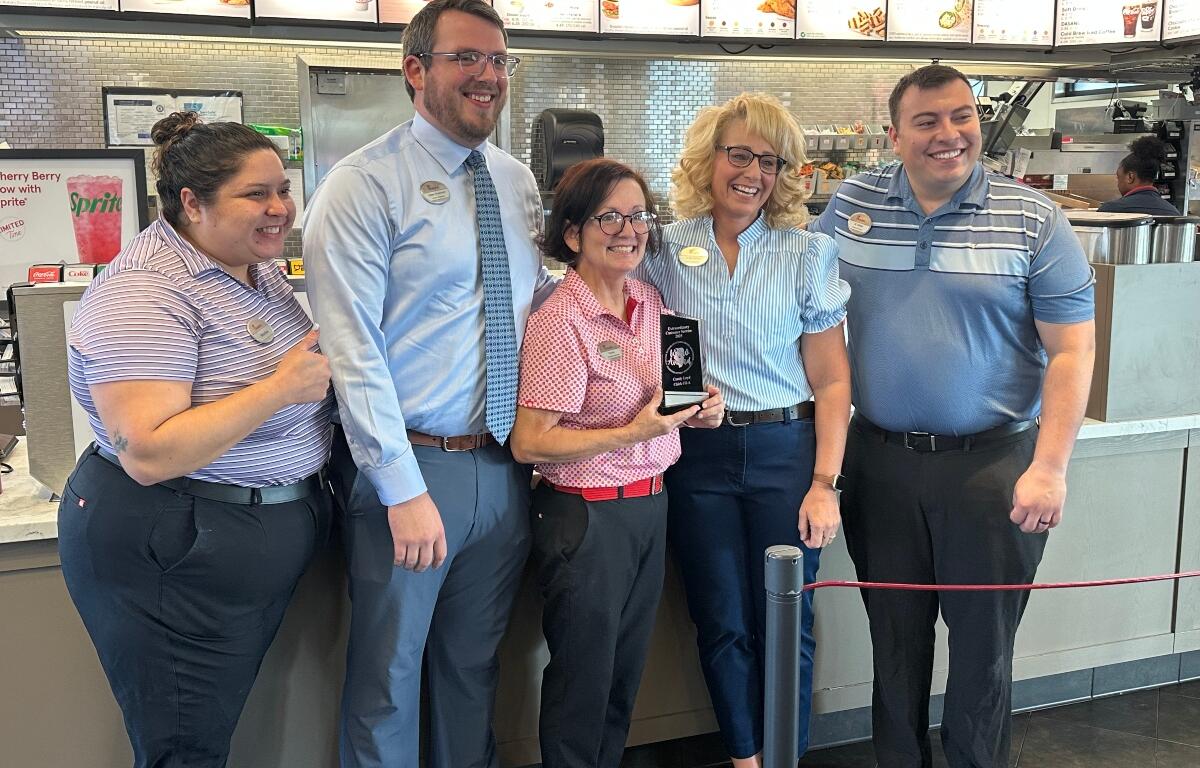Some of Candy Loyd's Chick-Fil-A co-workers help her celebrate her "WOW Award".