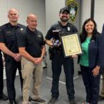 Officer Matthew Torres receives an award from Springfield Mayor Misty Buscher.