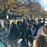 A crowd watches a news conference after the Sean Grayson trial verdict Wednesday in Peoria.