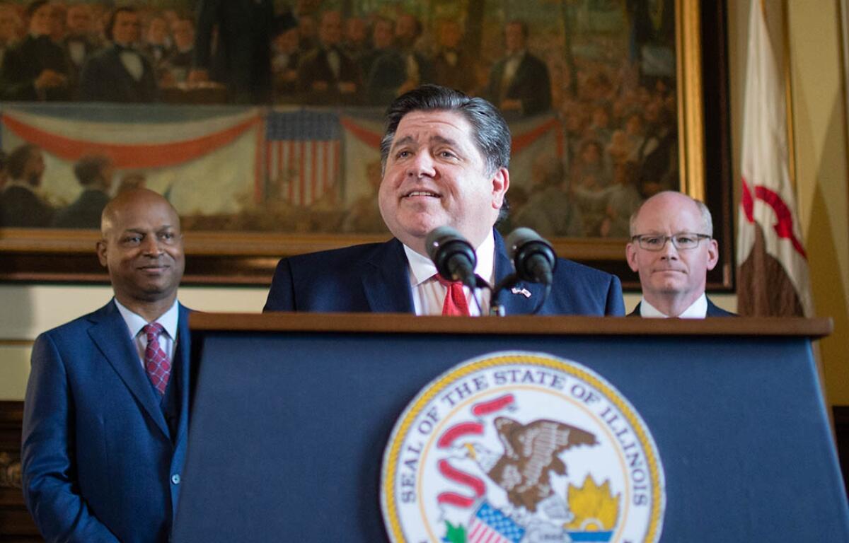 Gov. JB Pritzker holds a news conference alongside House Speaker Chris Welch, left, and Senate President Don Harmon in May 2023 at the Illinois Capitol. (Capitol News Illinois photo by Jerry Nowicki)