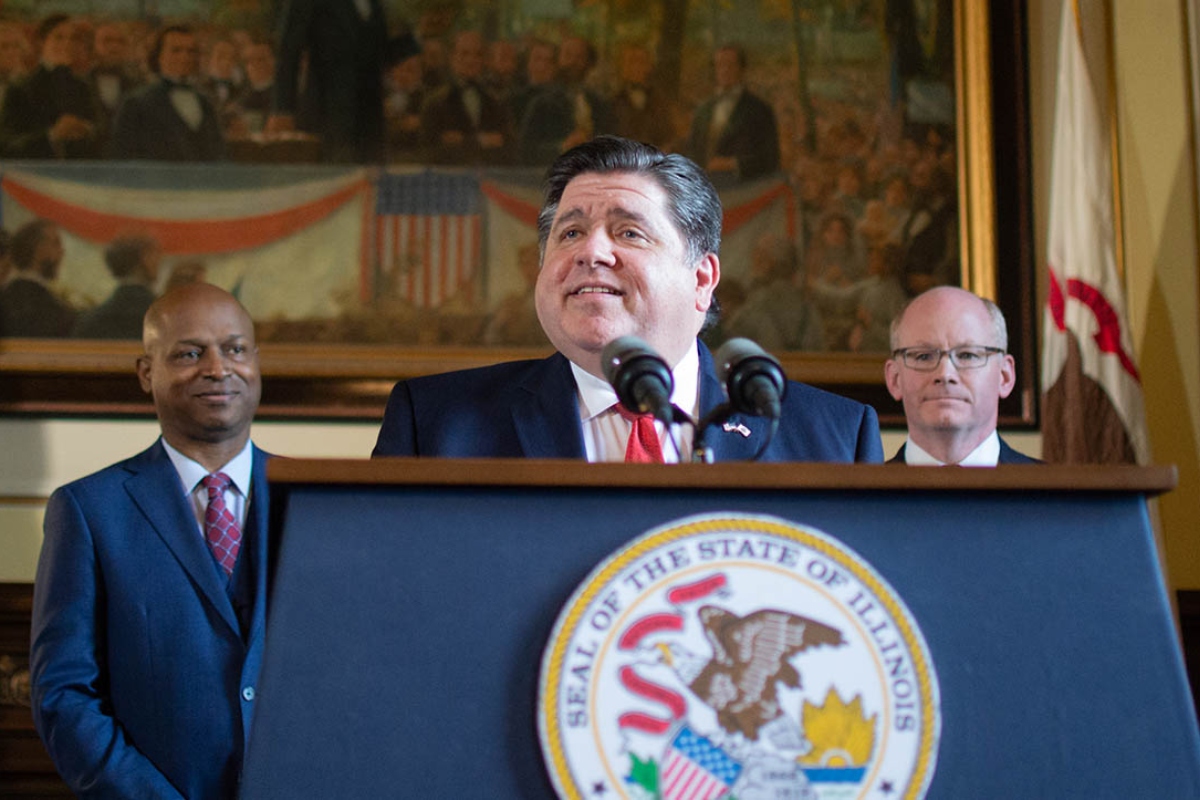Gov. JB Pritzker holds a news conference alongside House Speaker Chris Welch, left, and Senate President Don Harmon in May 2023 at the Illinois Capitol. (Capitol News Illinois photo by Jerry Nowicki)