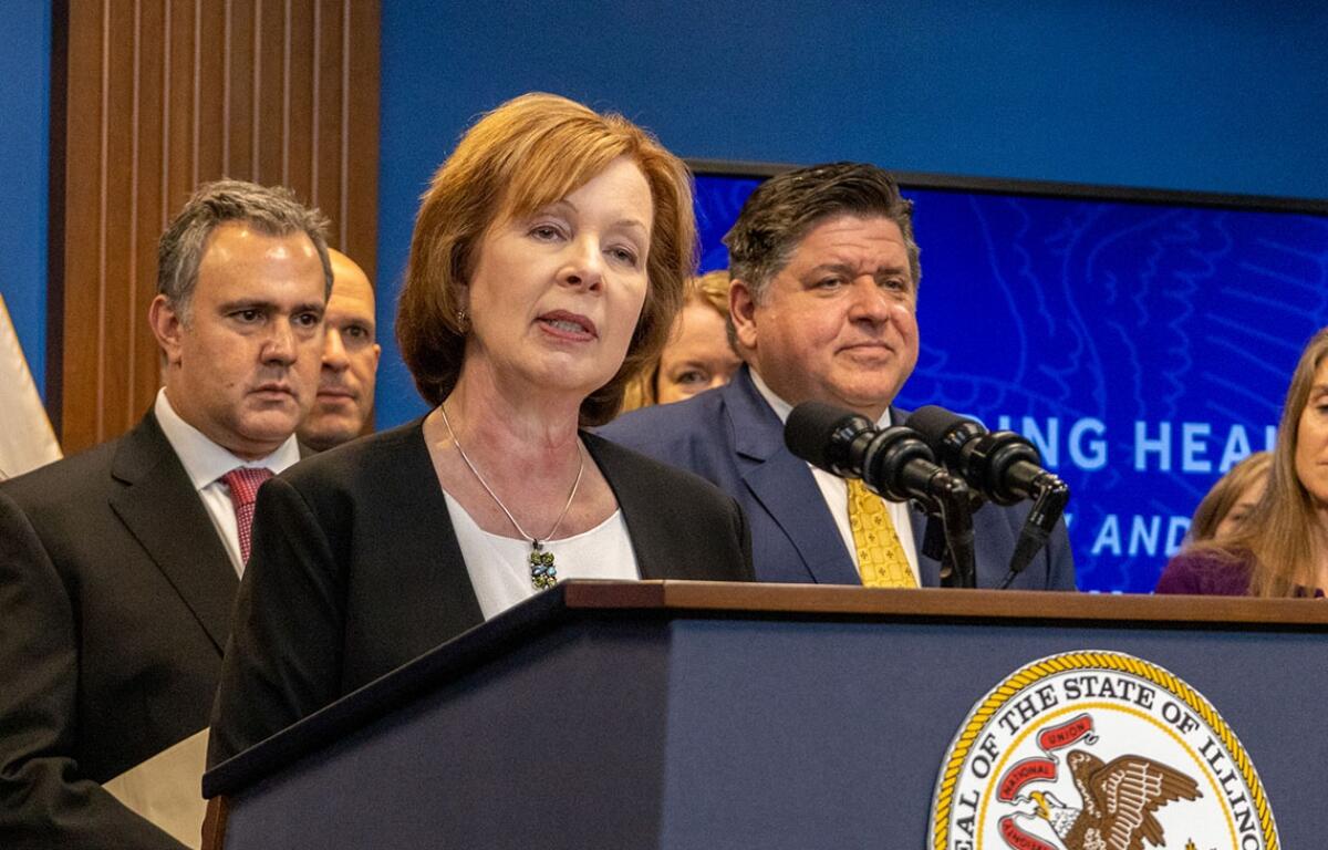 Ann Gillespie, a former state senator who is now the state’s insurance department director, is pictured at a news conference with Gov. JB Pritzker and others in 2023. (Capitol News Illinois photo by Andrew Adams)