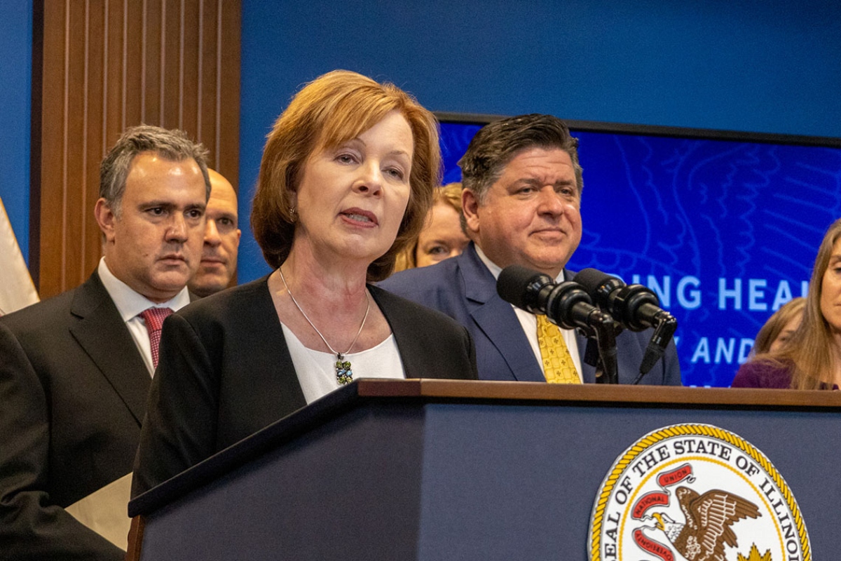 Ann Gillespie, a former state senator who is now the state’s insurance department director, is pictured at a news conference with Gov. JB Pritzker and others in 2023. (Capitol News Illinois photo by Andrew Adams)