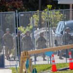 A group of people in military fatigues walks into an Immigration and Customs Enforcement facility in Broadview on Thursday, Oct. 9. National Guard troops were deployed to the facility earlier in the day. (Capitol News Illinois photo by Andrew Adams)