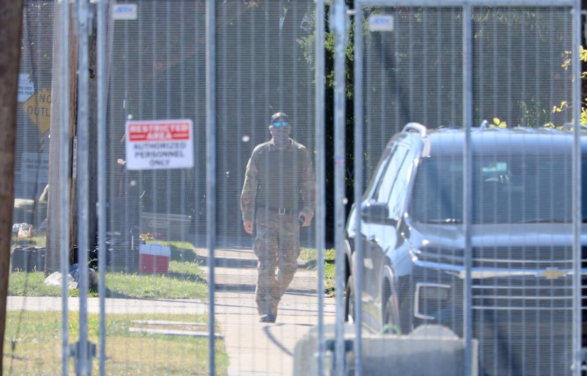 A man in military-style fatigues walks outside an Immigration and Customs Enforcement facility in Broadview on Oct. 9. National Guard troops were deployed to the facility earlier in the day. (Capitol News Illinois photo by Andrew Adams)