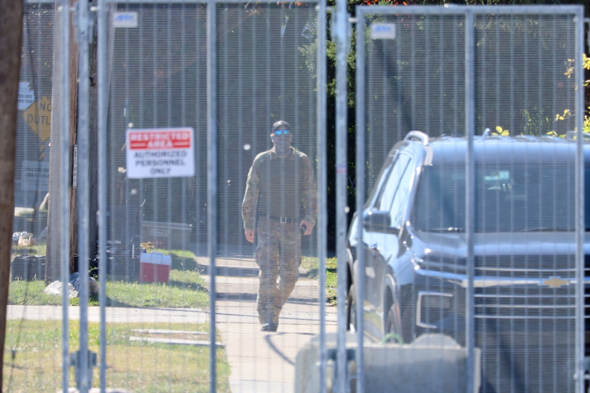 A man in military-style fatigues walks outside an Immigration and Customs Enforcement facility in Broadview on Oct. 9. National Guard troops were deployed to the facility earlier in the day. (Capitol News Illinois photo by Andrew Adams)