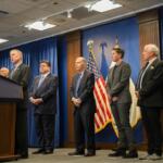 Ret. Maj. Gen. Randy Manner condemns the use of military troops to support domestic law enforcement at an Oct. 16 news conference alongside Gov. JB Pritzker and other retired military officers. Also pictured, from left to right: Lt. Gen. Charles Luckey, Gov. JB Pritzker, Maj. Gen. William Enyart, Capt. Janessa Goldbeck, Maj. Gen. Paul Eaton and Rear Adm. Michael Smith. (Capitol News Illinois photo by Andrew Adams)