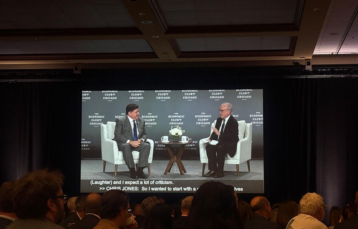 Gov. JB Pritzker addresses the Economic Club of Chicago on Tuesday, Oct. 21, as his image is projected on a screen. (Capitol News Illinois photo by Maggie Dougherty)