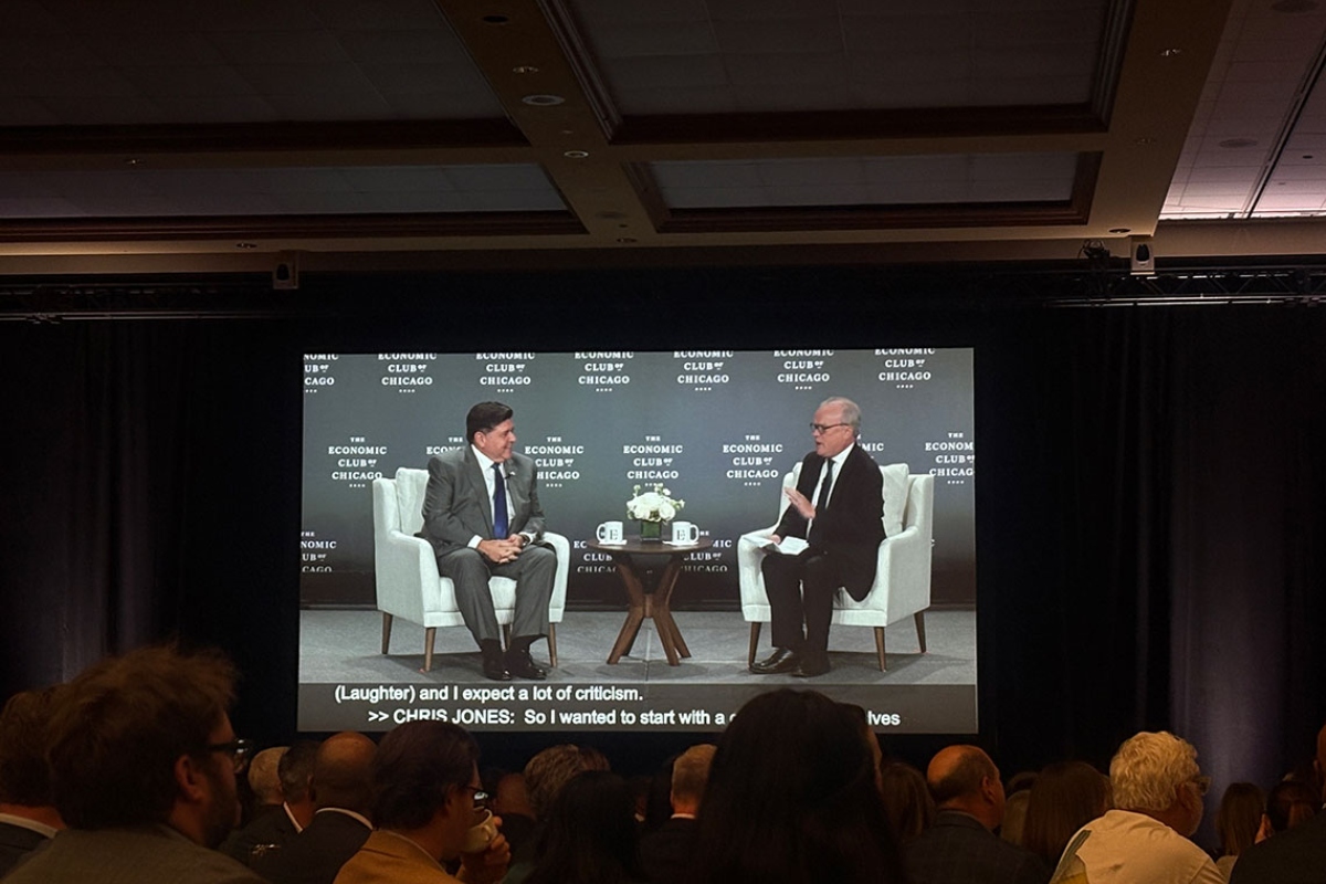 Gov. JB Pritzker addresses the Economic Club of Chicago on Tuesday, Oct. 21, as his image is projected on a screen. (Capitol News Illinois photo by Maggie Dougherty)
