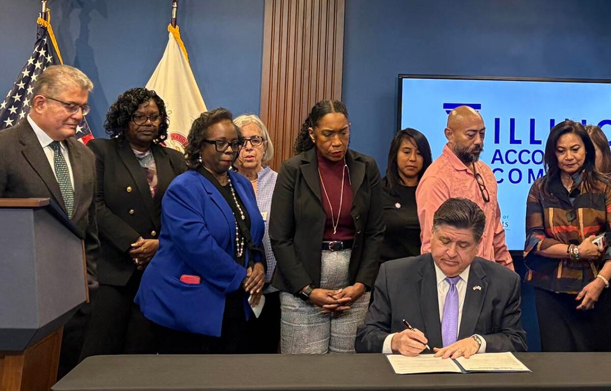 Gov. JB Pritzker signs an executive order in Chicago on Thursday, Oct. 23, creating the Illinois Accountability Commission to document abuses by federal agents. (Capitol News Illinois photo by Maggie Dougherty)
