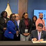 Gov. JB Pritzker signs an executive order in Chicago on Thursday, Oct. 23, creating the Illinois Accountability Commission to document abuses by federal agents. (Capitol News Illinois photo by Maggie Dougherty)