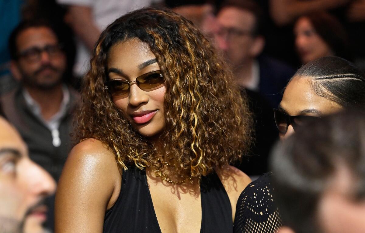 WNBA basketbal player Angel Reese sits at ringside during a super welterweight boxing match between Callum Walsh and Fernando Vargas Jr. in Las Vegas, Saturday, Sept. 13, 2025. (AP Photo/David Becker)