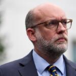 Russell Vought, Office of Management and Budget director, listens as he addresses members of the media outside the West Wing at the White House in Washington, Monday, Sept. 29, 2025, in Washington. (AP Photo/Evan Vucci)
