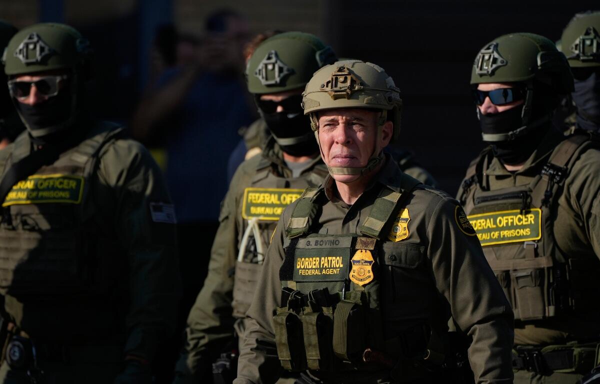 Greg Bovino, the chief patrol agent for the U.S. Border Patrol El Centro sector, center, stands with federal immigration agents near an Immigration and Customs Enforcement facility in Broadview, Ill., Friday, Oct. 3, 2025. (AP Photo/Erin Hooley)