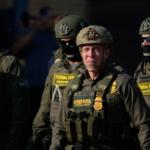 Greg Bovino, the chief patrol agent for the U.S. Border Patrol El Centro sector, center, stands with federal immigration agents near an Immigration and Customs Enforcement facility in Broadview, Ill., Friday, Oct. 3, 2025. (AP Photo/Erin Hooley)