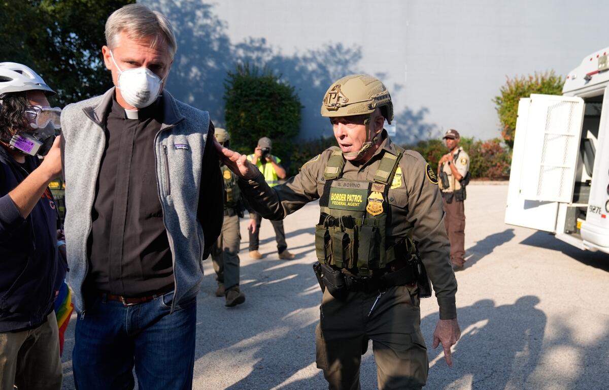 Greg Bovino, the chief patrol agent for the U.S. Border Patrol El Centro sector, right, walks along protester that was detained near an Immigration and Customs Enforcement facility in Broadview, Ill., Friday, Oct. 3, 2025. (AP Photo/Erin Hooley)