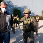 Greg Bovino, the chief patrol agent for the U.S. Border Patrol El Centro sector, right, walks along protester that was detained near an Immigration and Customs Enforcement facility in Broadview, Ill., Friday, Oct. 3, 2025. (AP Photo/Erin Hooley)