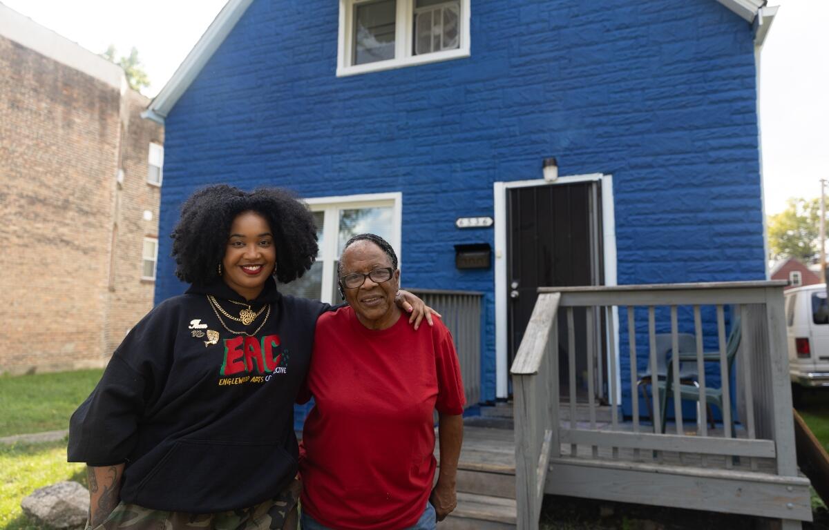 Artist Tonika Lewis Johnson and local resident Justine Stephens, right, stand for portrait in the 6500-block of South Aberdeen Street in Chicago's Englewood neighborhood, on Monday, Oct. 6, 2025. (AP Photo/Talia Sprague)