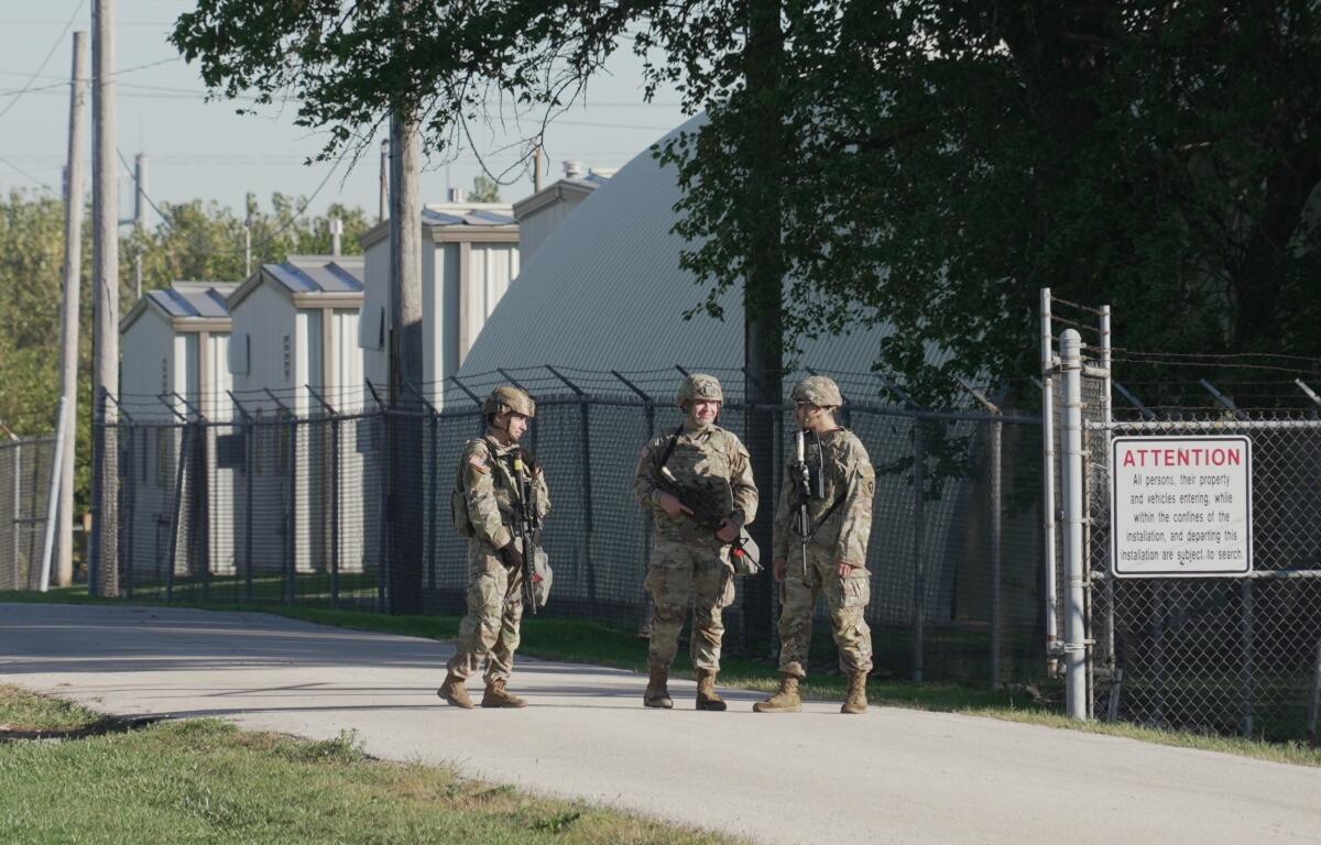 Military personnel in uniform, with the Texas National Guard patch on, are seen at the U.S. Army Reserve Center, Wednesday, Oct. 8, 2025, in Elwood, Ill., a suburb of Chicago. (AP Photo/Laura Bargfeld)