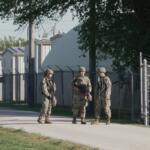 Military personnel in uniform, with the Texas National Guard patch on, are seen at the U.S. Army Reserve Center, Wednesday, Oct. 8, 2025, in Elwood, Ill., a suburb of Chicago. (AP Photo/Laura Bargfeld)