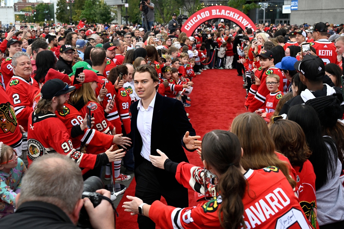 Chicago Blackhawks center Connor Bedard greets fans on a red carpet before an NHL hockey game against the Montreal Canadiens, Saturday, Oct. 11, 2025, in Chicago. (AP Photo/Matt Marton)