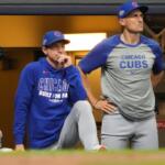 Chicago Cubs manager Craig Counsell, left, and bench coach Ryan Flaherty, right, look on from the dugout during the seventh inning of Game 5 of baseball's National League Division Series against the Milwaukee Brewers, Saturday, Oct. 11, 2025, in Milwaukee.