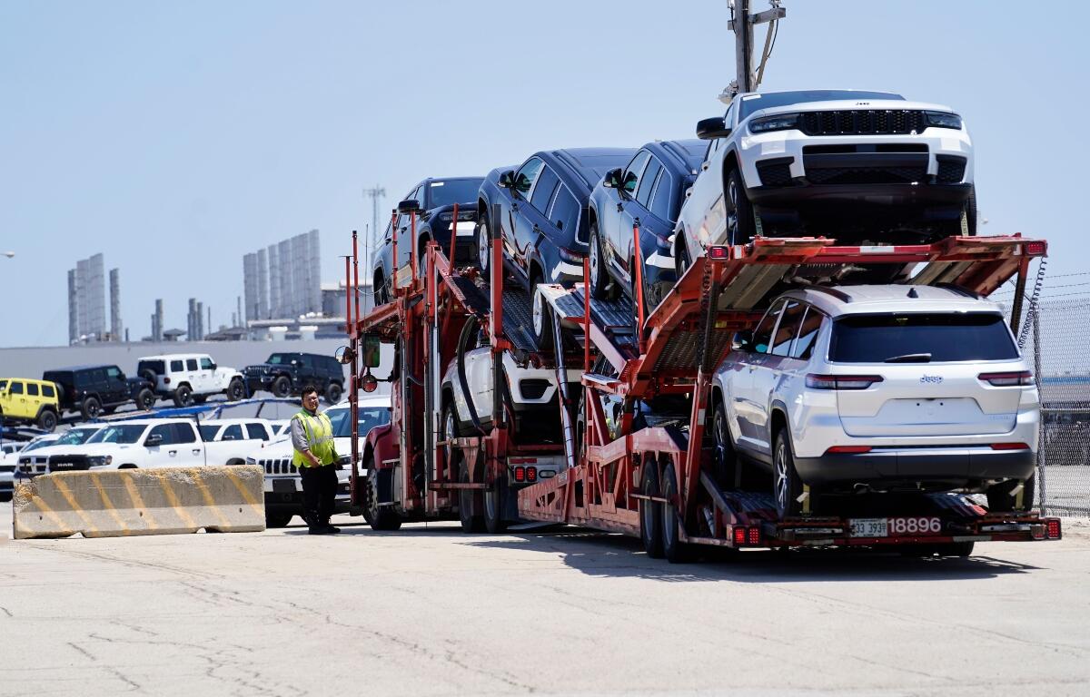 FILE - A transport carrying new cars arrives at a Stellantis facility July 10, 2023, in Belvidere. Ill. (AP Photo/Charles Rex Arbogast, File)
